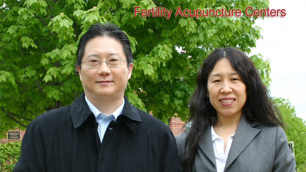 The husband and wife fertility acupuncture practitioners outdoors.